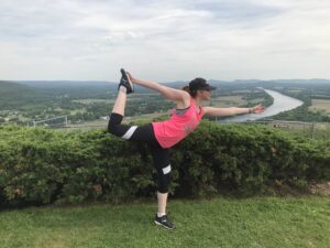 Lauren doing yoga on a mountain posing